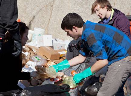 students sort trash at football game